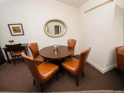 a dining room with a table and chairs and a mirror at Stylish Venice Escape Near the Marina & Beachfront in Los Angeles