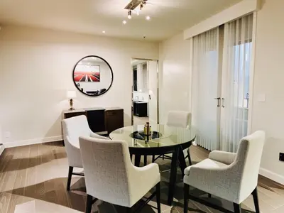 a dining room with a table and chairs and a mirror at Stylish Venice Escape Near the Marina & Beachfront in Los Angeles