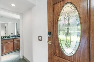 a wooden door with a stained glass window at Lakeside Comfort condo in Lake Arrowhead