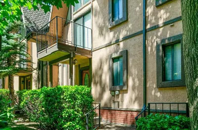 an apartment building with a staircase and a balcony at Lakeside Comfort condo in Lake Arrowhead