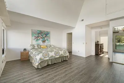 a bedroom with a bed and a painting on the wall at Lakeside Comfort condo in Lake Arrowhead