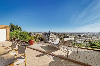a balcony with chairs and a view of the city at Chateau Lumier by Stay Awhile in Los Angeles