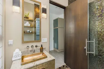 a bathroom with a sink and a shower at Chateau Lumier by Stay Awhile in Los Angeles