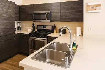 a kitchen with a sink and a stove at Cozy Home Close to Disney in Orange