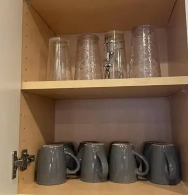 a row of mugs sitting on a shelf at Cozy Home Close to Disney in Orange