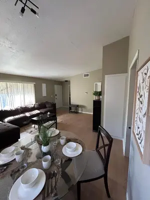 a living room with a table and chairs and a couch at Spacious Fully Furnished 3BR Fully Fenced Home in Riverside