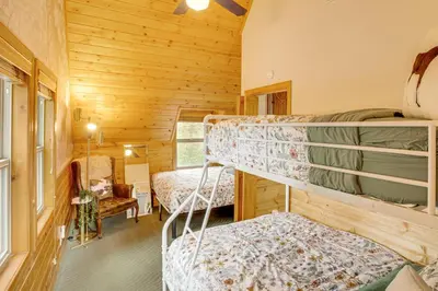 a bedroom with two bunk beds in a cabin at 3 Mi to Snow Summit Charming Home with Fenced Yard in Big Bear Lake