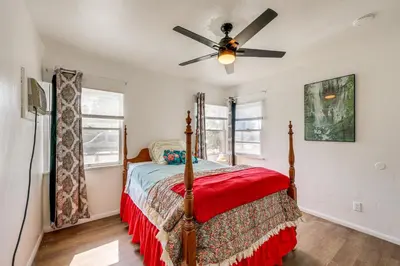 a bedroom with a bed and a ceiling fan at High Walkability! Extended Stay in Riverside in Riverside