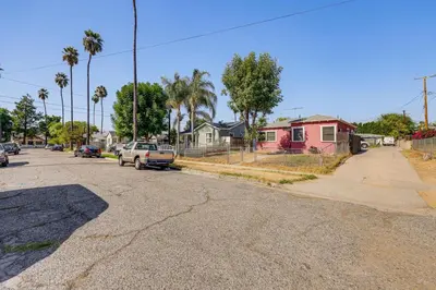 an empty street with cars parked on the side of the road at High Walkability! Extended Stay in Riverside in Riverside