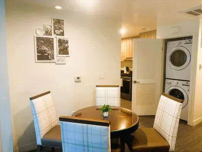 a kitchen and dining room with a table and a washing machine at 3 bedroom Home Casa Serenity Central Los Angeles in Los Angeles