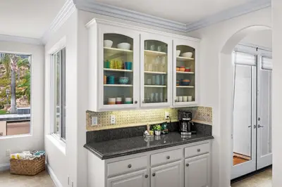 a kitchen with white cabinets and a counter at Modern Hilltop Retreat in Lakeside Park