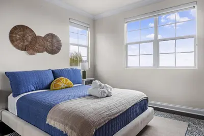 a bedroom with a blue bed with a stuffed animal on it at Modern Hilltop Retreat in Lakeside Park
