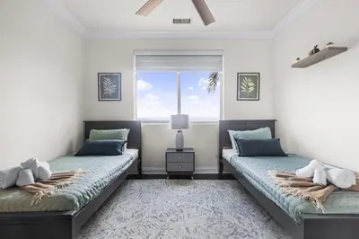 two beds in a room with a window at Modern Hilltop Retreat in Lakeside Park