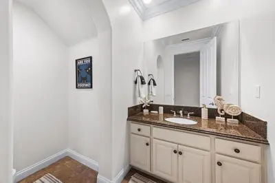 a bathroom with a sink and a mirror at Modern Hilltop Retreat in Lakeside Park