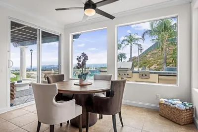 a dining room with a table and chairs and a large window at Modern Hilltop Retreat in Lakeside Park
