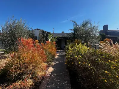 a garden with colorful bushes and a walkway at Charming Cozy Studio 5 Minutes from Sofi Stadium in Los Angeles