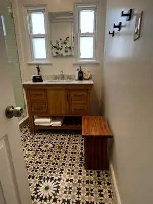 a bathroom with a sink and a wooden table at Charming Cozy Studio 5 Minutes from Sofi Stadium in Los Angeles