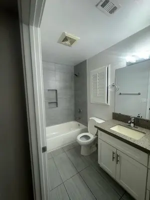 a bathroom with a toilet and a tub and a sink at Soulistic Vibes Normandie in Los Angeles