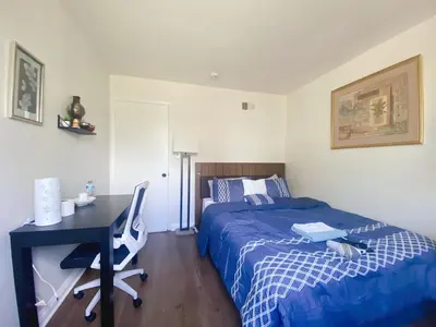 a bedroom with a bed and a desk and a bed and a deskictericter at Pomona Cozy Queen Bedroom in Pomona