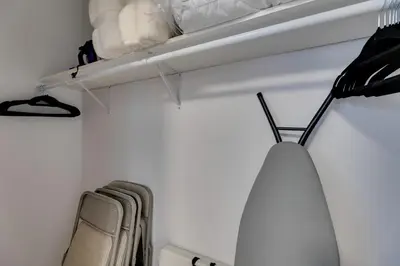 a closet with white walls and a shelf with towels at 4 Mi to Old Pasadena Walkable Studio in Alhambra