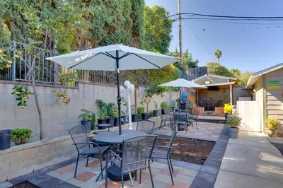 a table and chairs with an umbrella on a patio at 4 Mi to Old Pasadena Walkable Studio in Alhambra
