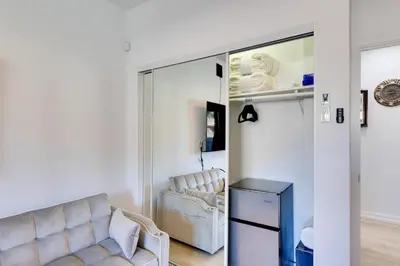 a living room with a couch and a mirror at 2 Blocks to Main St Foodies Paradise in Alhambra in Alhambra