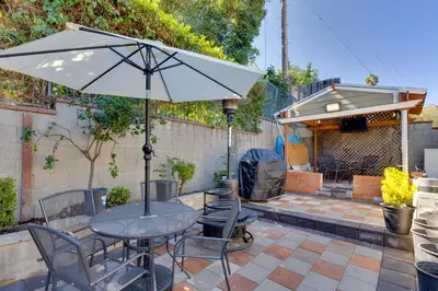a table and chairs with an umbrella on a patio at 2 Blocks to Main St Foodies Paradise in Alhambra in Alhambra