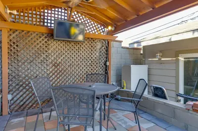 a patio with a table and chairs and a tv on the wall at 2 Blocks to Main St Foodies Paradise in Alhambra in Alhambra