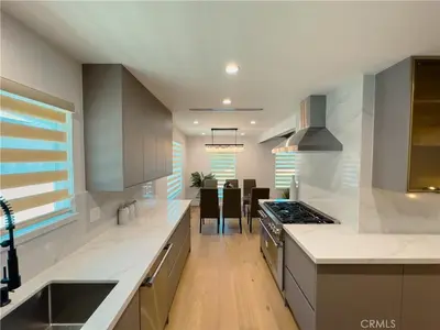 a kitchen with white counters and a stove top oven at Splash and Stay Studio City in Los Angeles