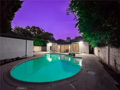 a swimming pool in a backyard at night at Splash and Stay Studio City in Los Angeles