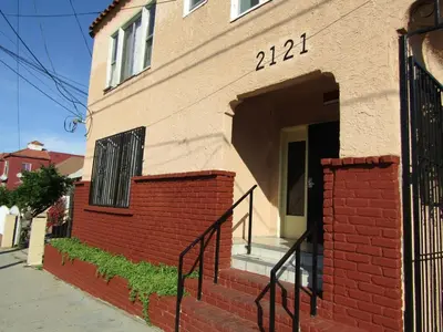 a house with a brick wall and a door at Remodeled Chick Studio Near Downtown LA, AC, WiFI, WD, Snack in Los Angeles