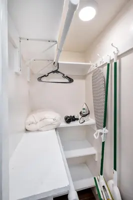 a room with white walls and white stairs and a surfboard at Remodeled Chick Studio Near Downtown LA, AC, WiFI, WD, Snack in Los Angeles