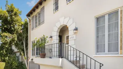 a white house with a balcony and a window at Cozy Hollywood Hideaway w Private Patio Easy City Access Casa Camrose by AvantStay in Los Angeles
