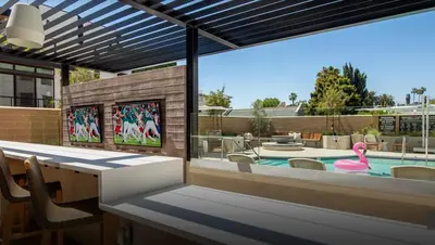 a patio with a swimming pool and a pink flamingo at The Jade Hill Views - Penthouse - Pool, Gym, Balcony in Los Angeles