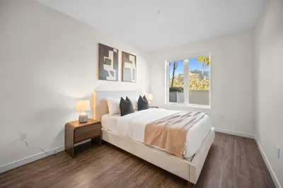 a white bedroom with a bed and a window at The Jade Hill Views - Penthouse - Pool, Gym, Balcony in Los Angeles