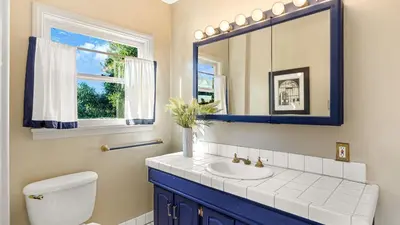a bathroom with a sink and a mirror at Spanish Revival Charm in Silver Lake w Patio BBQ Walkable Location Maltman Manor by AvantStay in Los Angeles