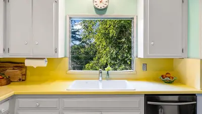 a kitchen with a sink and a window at Spanish Revival Charm in Silver Lake w Patio BBQ Walkable Location Maltman Manor by AvantStay in Los Angeles