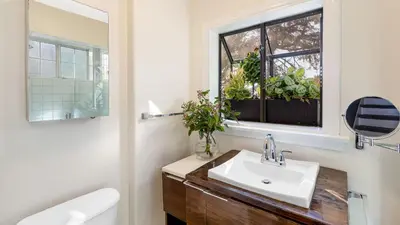 a bathroom with a sink and a window with potted plants at Spanish Revival Charm in Silver Lake w Patio BBQ Walkable Location Maltman Manor by AvantStay in Los Angeles