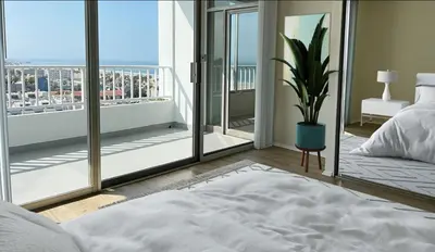 a bedroom with a bed and a view of a balcony at Santa Monica Ocenfront 2 Bedroom Villa with Parking in Los Angeles