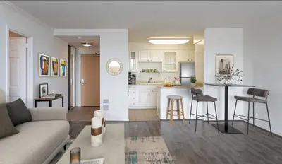a living room with a couch and a kitchen at Santa Monica Ocenfront 2 Bedroom Villa with Parking in Los Angeles