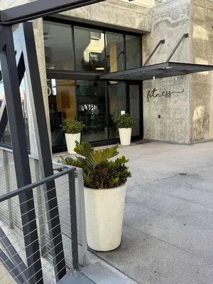 a restaurant with potted plants in front of a building at Contemporary 2BR Prime Hollywood Location in Los Angeles