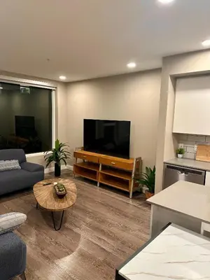a living room with a large flat screen tv at Contemporary 2BR Prime Hollywood Location in Los Angeles
