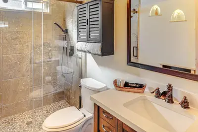 a bathroom with a shower and a toilet and a sink at Walk to Village! Romantic Pine Mtn Nature Escape in Pine Mountain Club