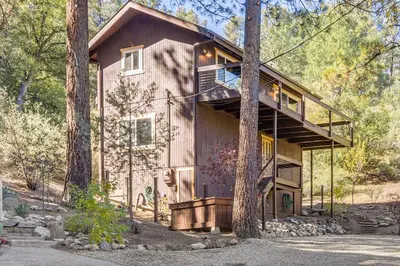 a house in the woods with a tree at Walk to Village! Romantic Pine Mtn Nature Escape in Pine Mountain Club