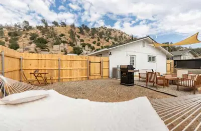 a backyard with a fence and a table and chairs at Huth Street Haven in Lake Isabella