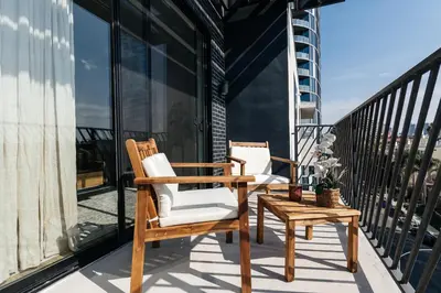 two chairs and a table on a balcony at High End Hotel Style 2B apartment with two balconies in Los Angeles