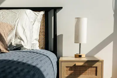 a bedroom with a bed and a lamp on a night stand at High End Hotel Style 2B apartment with two balconies in Los Angeles