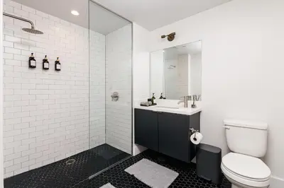 a bathroom with a toilet and a sink and a shower at High End Hotel Style 2B apartment with two balconies in Los Angeles