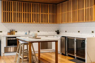 a kitchen with a table and stainless steel appliances at High End Hotel Style 2B apartment with two balconies in Los Angeles