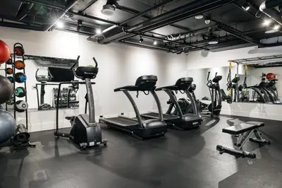 a gym with several exercise bikes in a room at High End Hotel Style 2B apartment with two balconies in Los Angeles